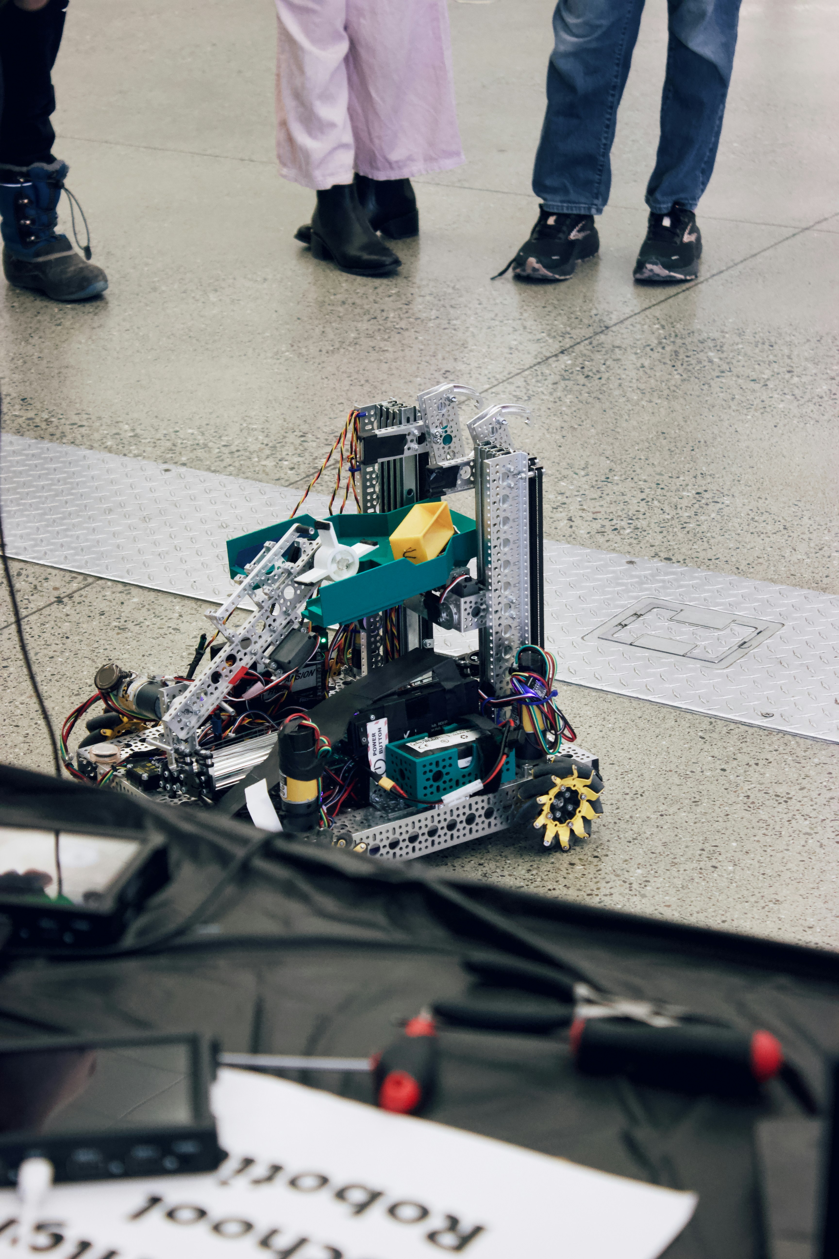 Robot prototype is being viewed by people.