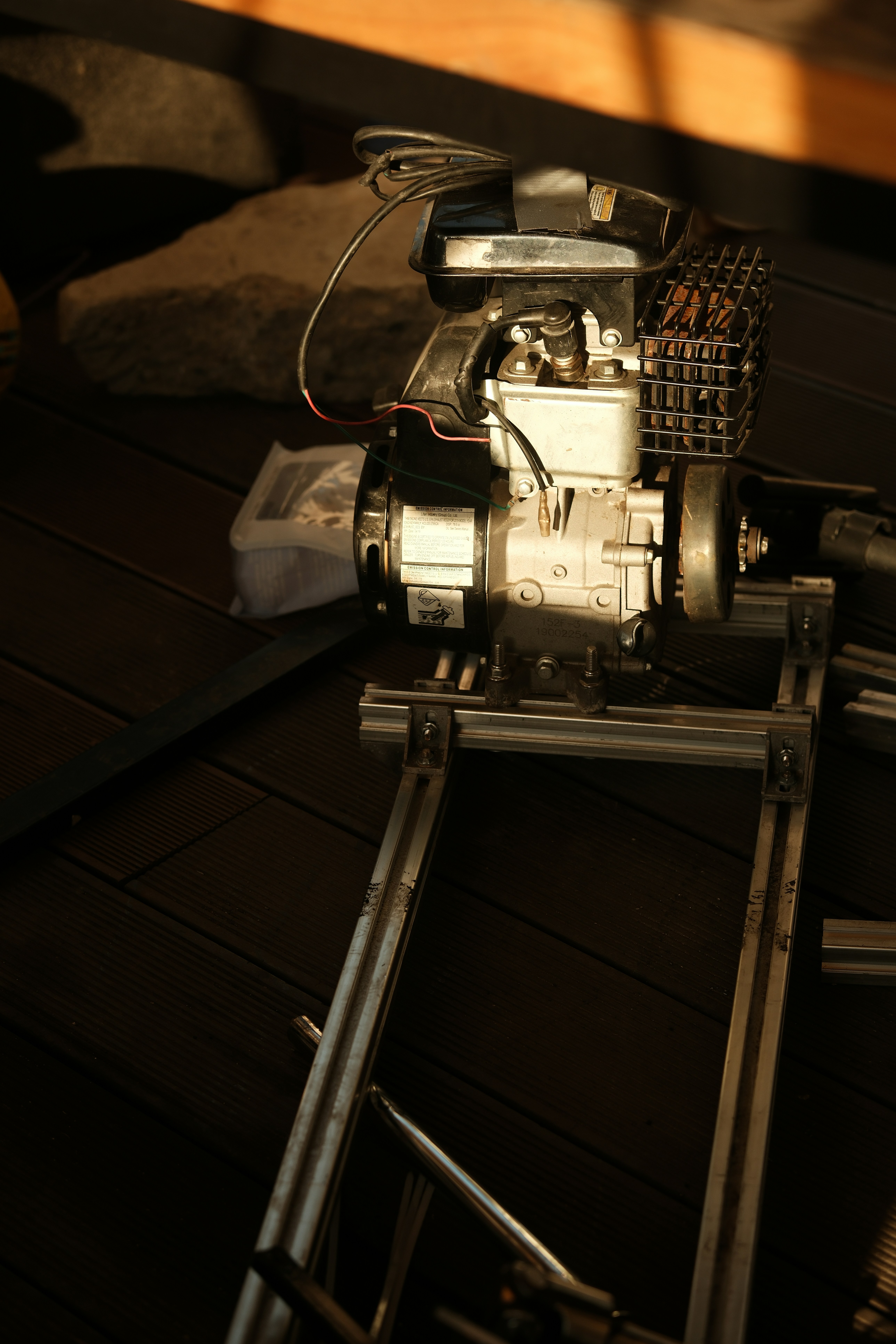 A small engine sits on a metal frame.