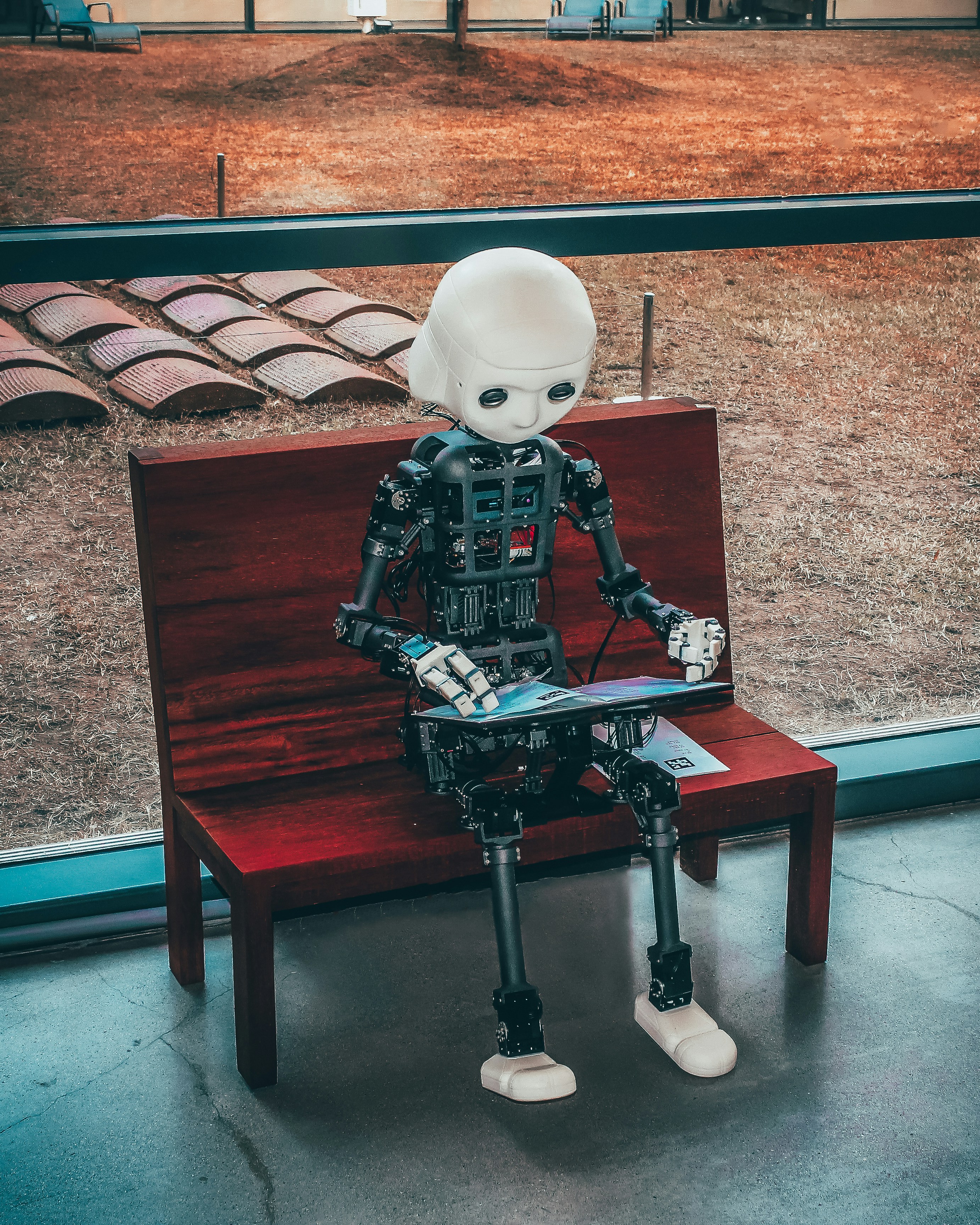 YouTube.com/@DreySantesson by Robotic Coding black and white robot toy on red wooden table
