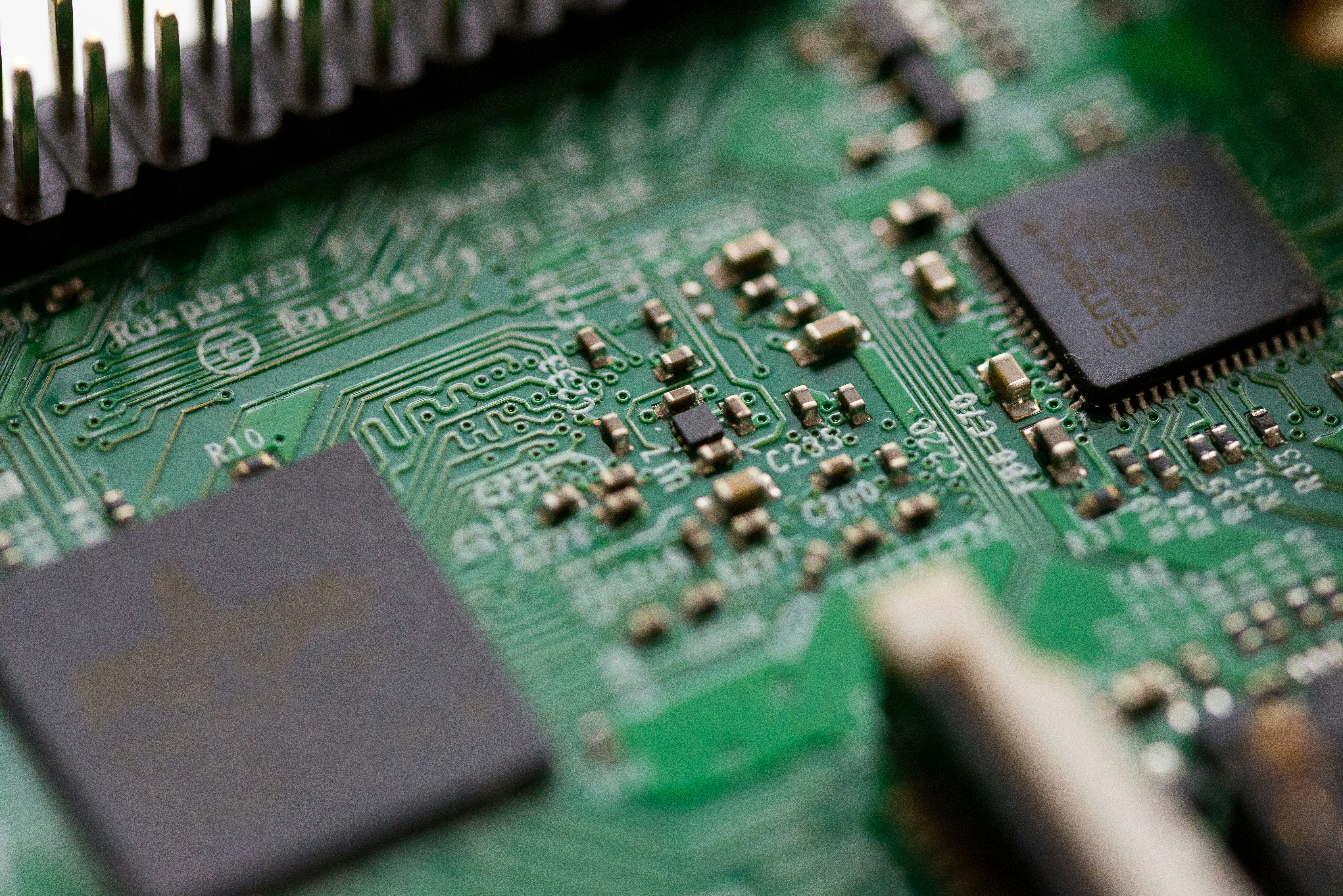 Close up technologies by Robotic Coding tilt-shift photography of green computer motherboard