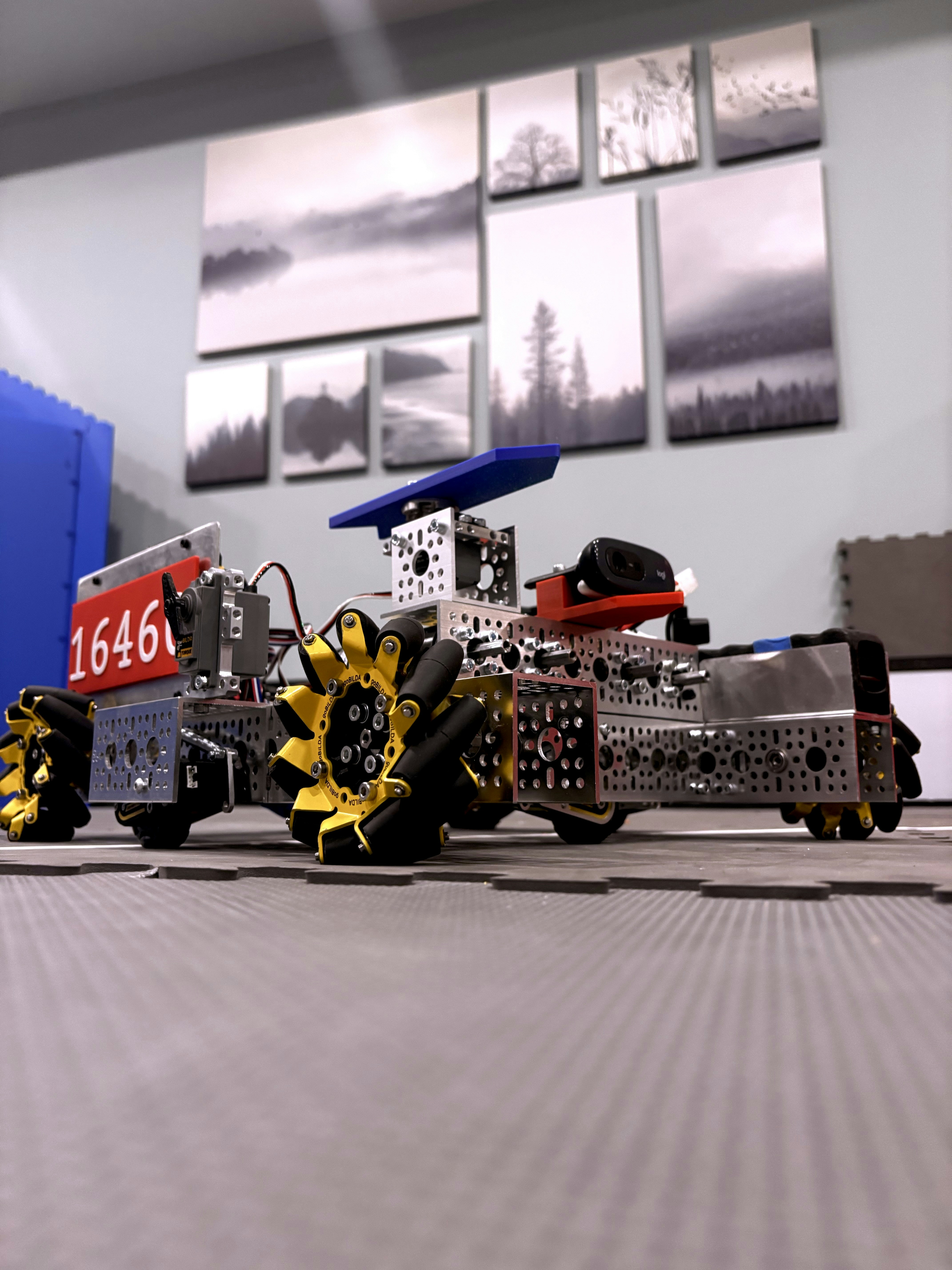 🕰️ A Brief History of Python in Robotics: From Scripting to Superbrains by Robotic Coding A complex robot with yellow wheels on a mat.
