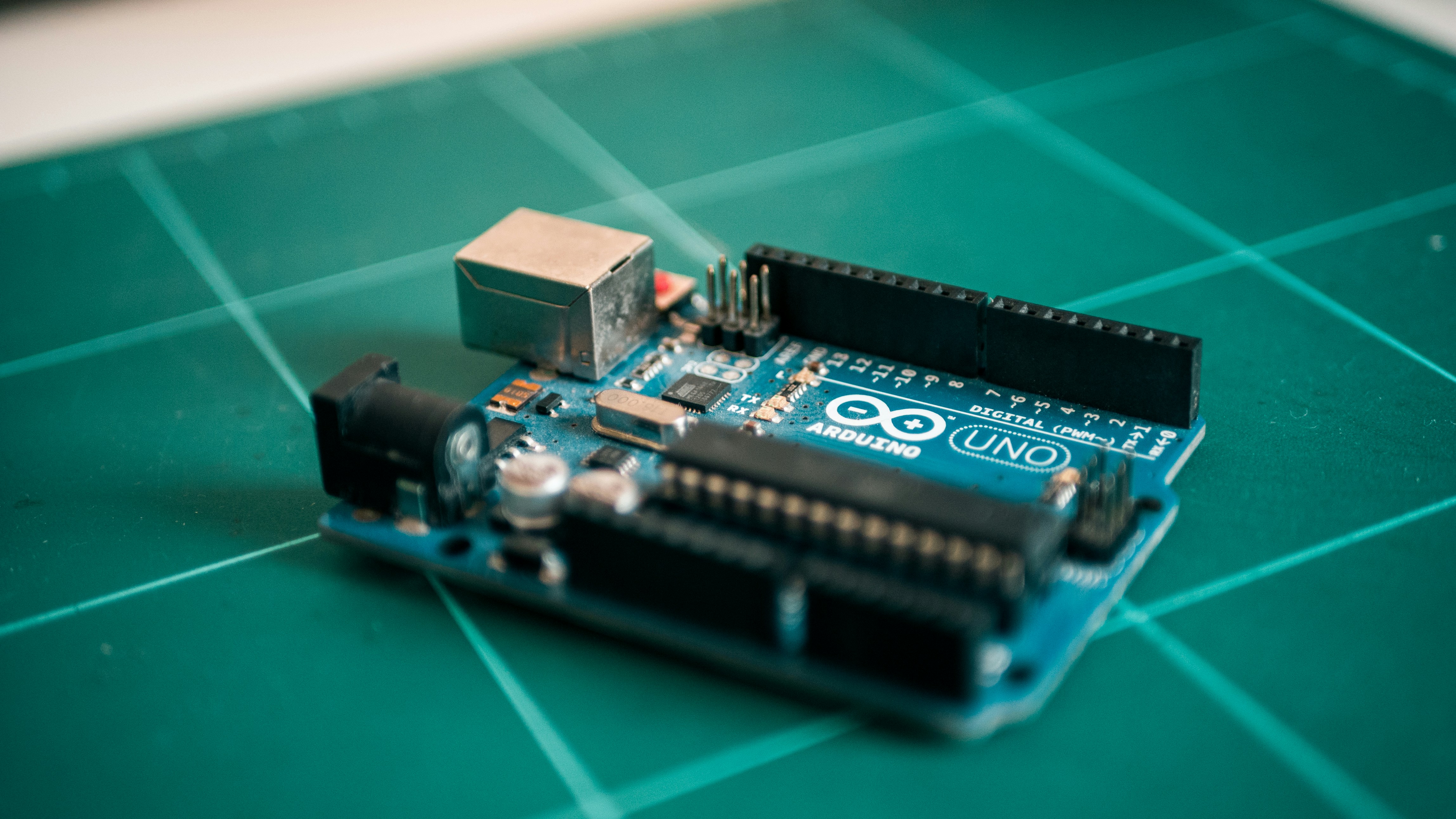 Arduino Uno on bench by Robotic Coding blue circuit board