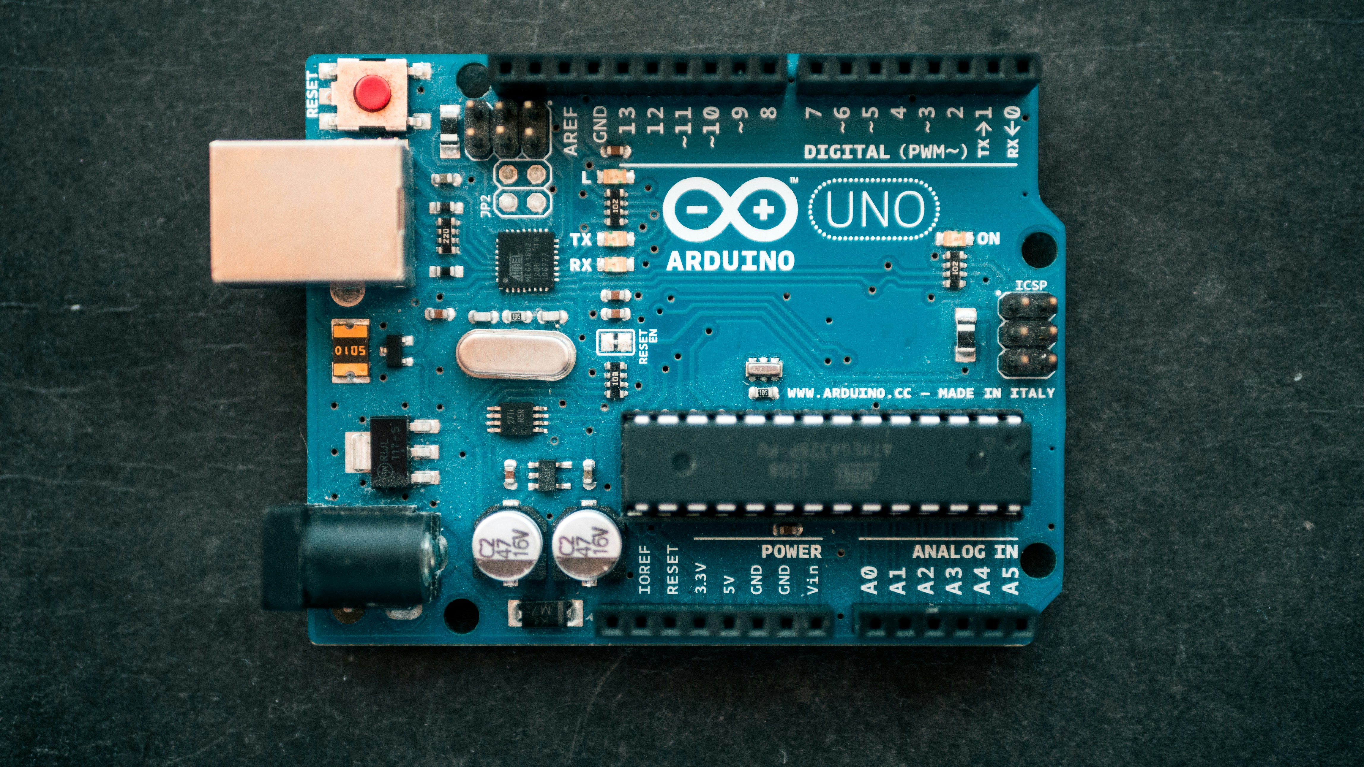 Arduino uno circuit board on black background by Robotic Coding brown Around computer motherboard