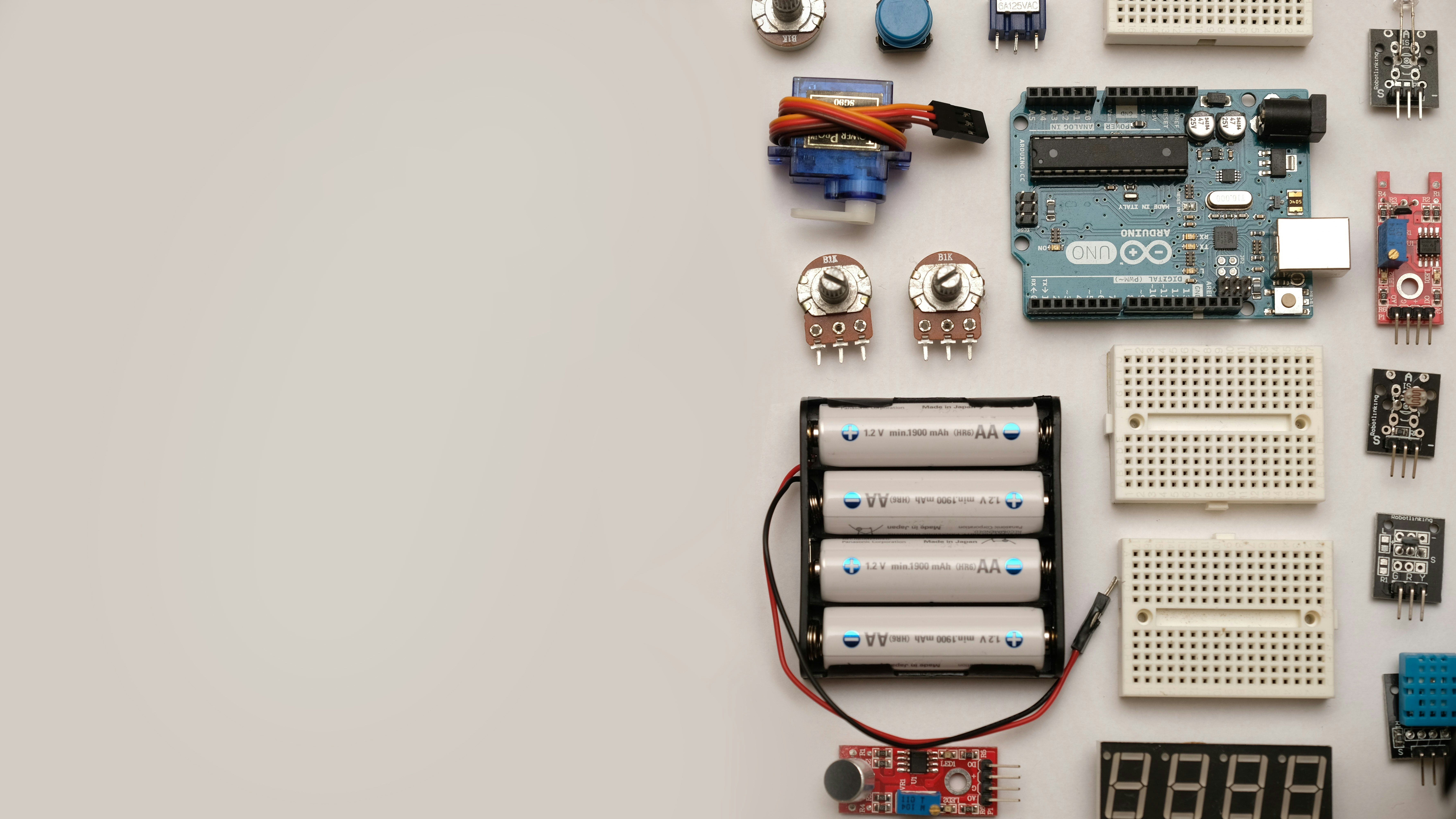 Flat lay out of electronic components with space for text. by Robotic Coding a group of electronic components laid out on a table