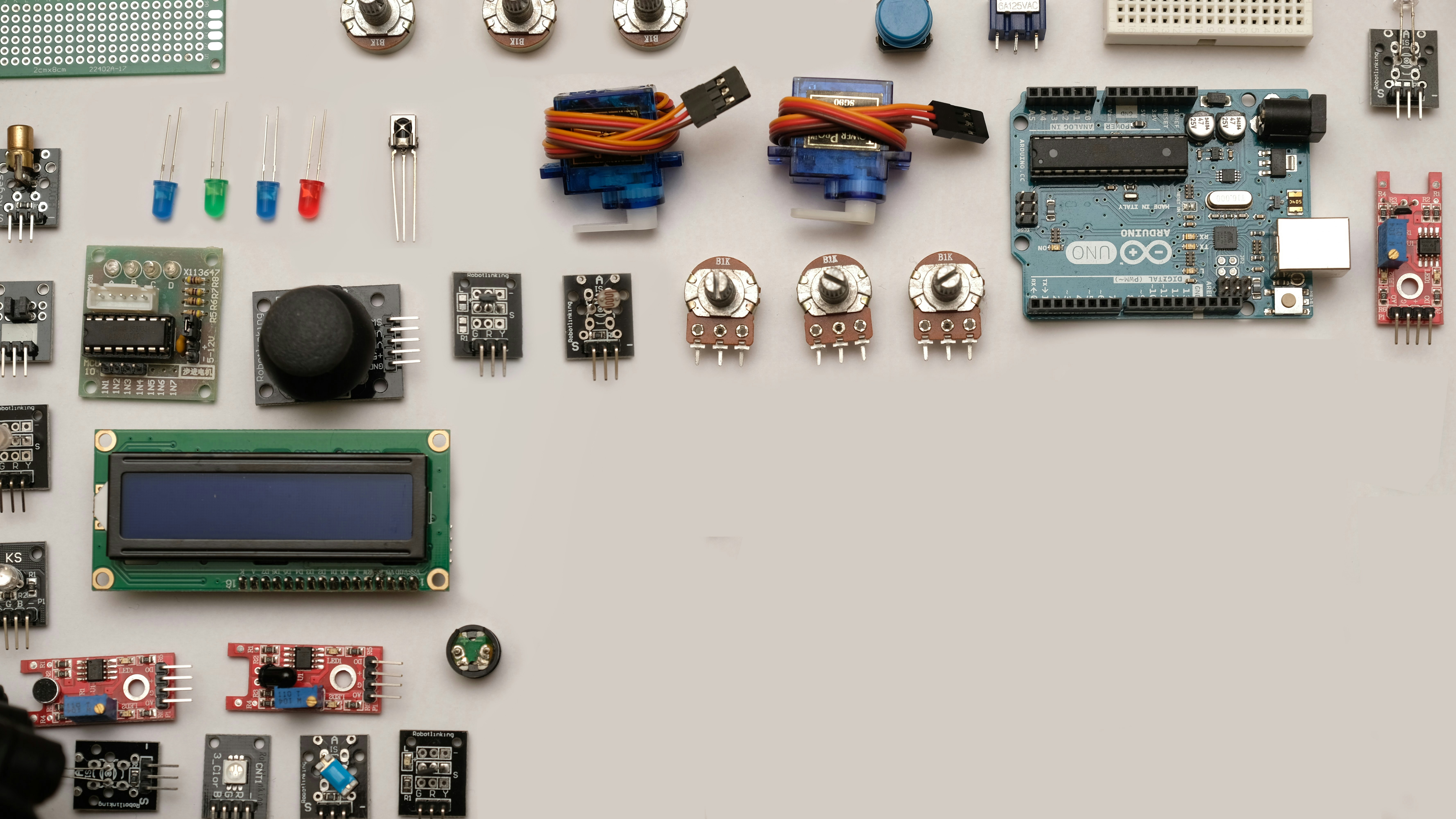Flat lay of electronics by Robotic Coding assorted-color capacitors on white surface