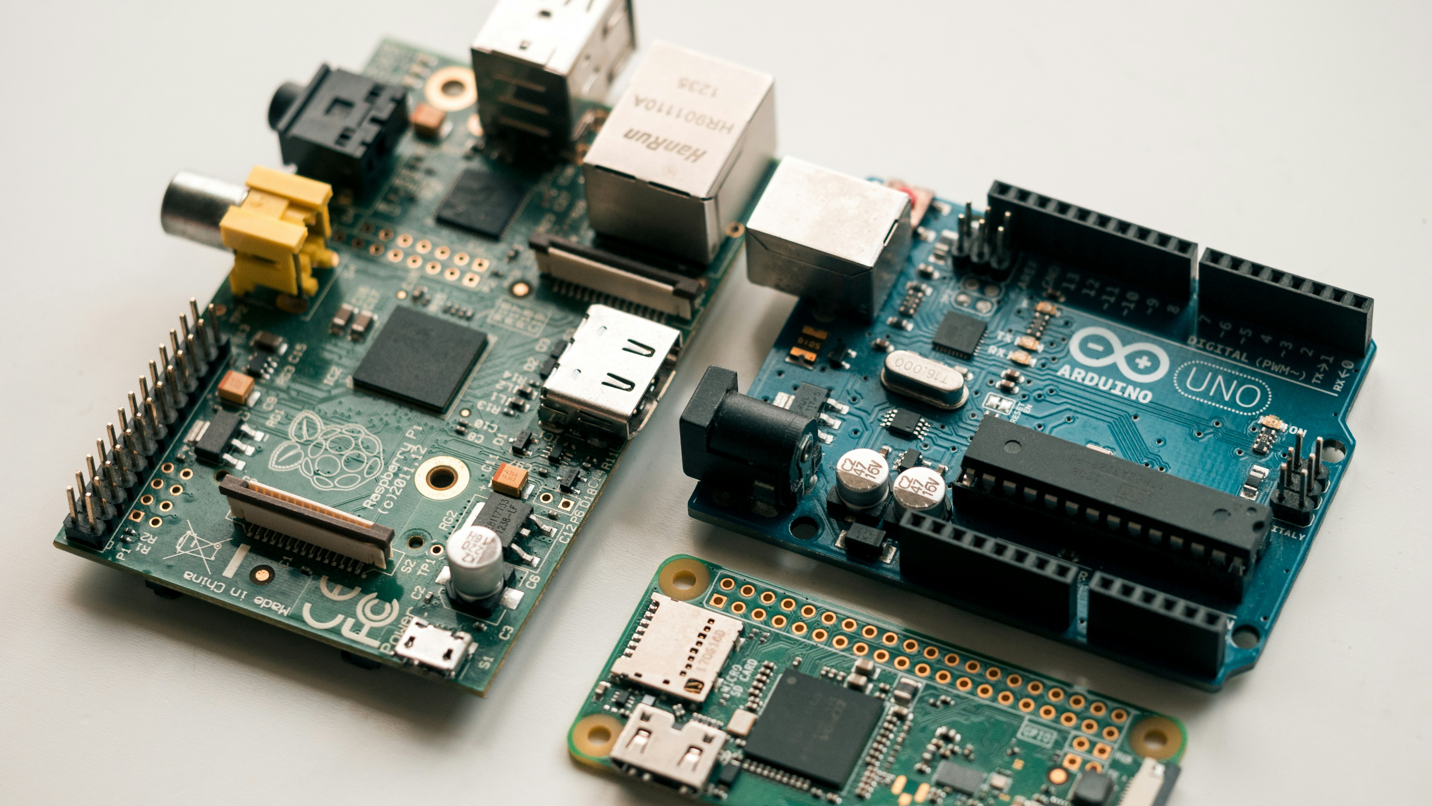 Raspberry pi model b, raspberry pi zero w and Arduino uno development boards by Robotic Coding green and black circuit board