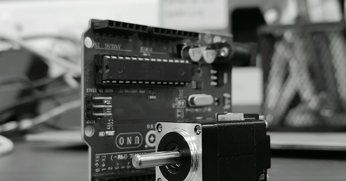 A Brief History of Arduino and Open-Source Robotics by Robotic Coding A camera sitting on top of a wooden table