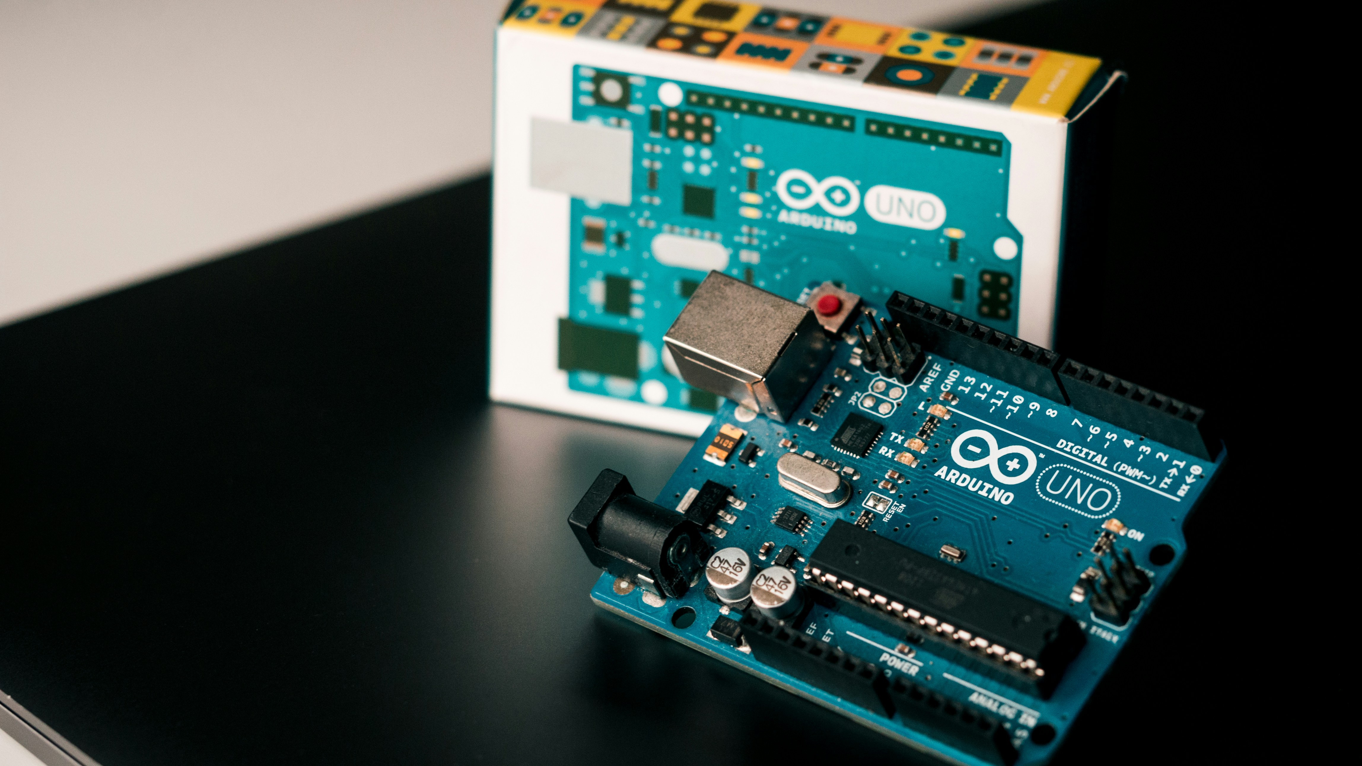 Arduino uno on macbook air by Robotic Coding blue and black circuit board