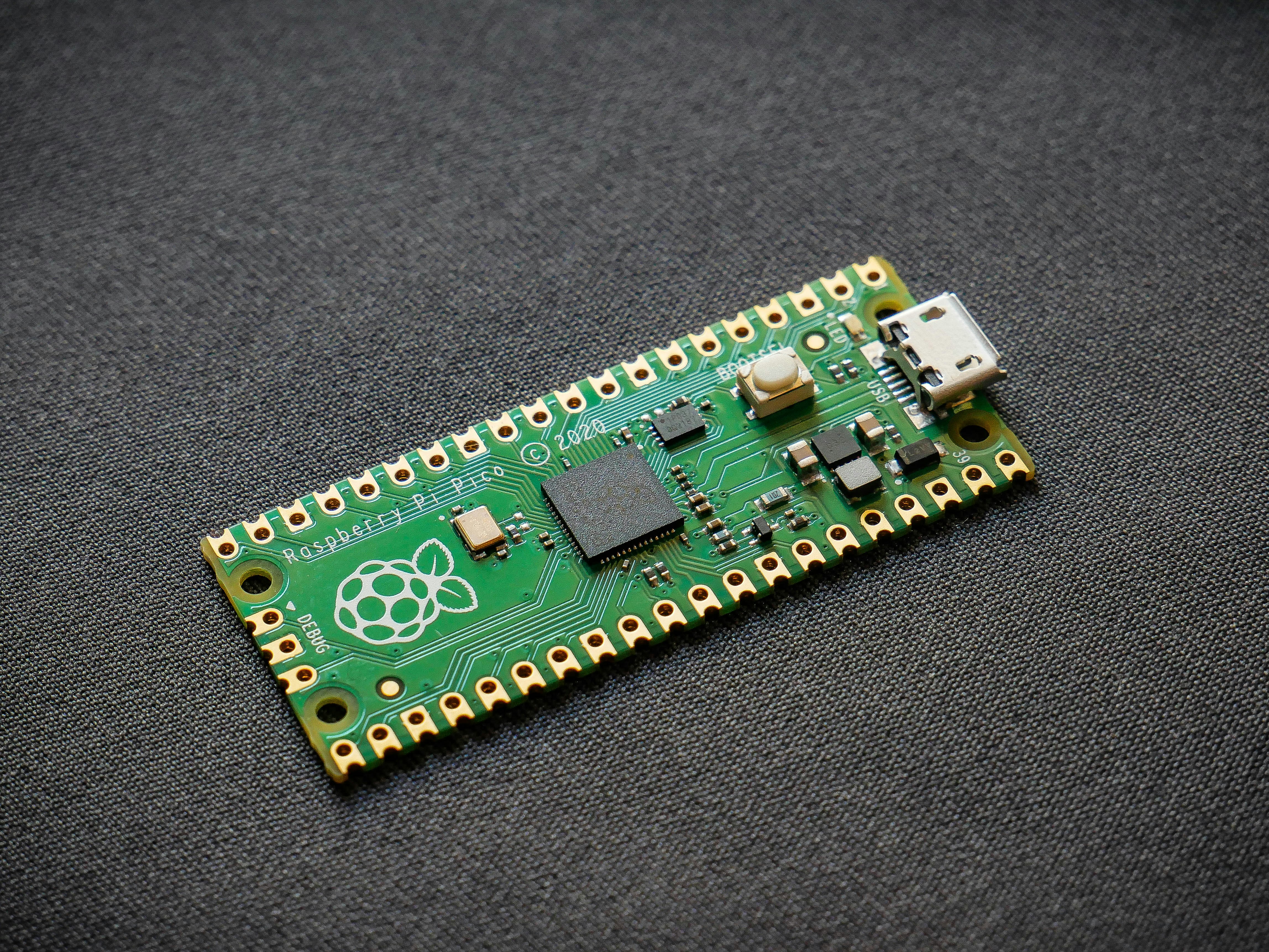 The new Raspberry Pi Pico RP2040 microcontroller development board. by Robotic Coding green and black circuit board