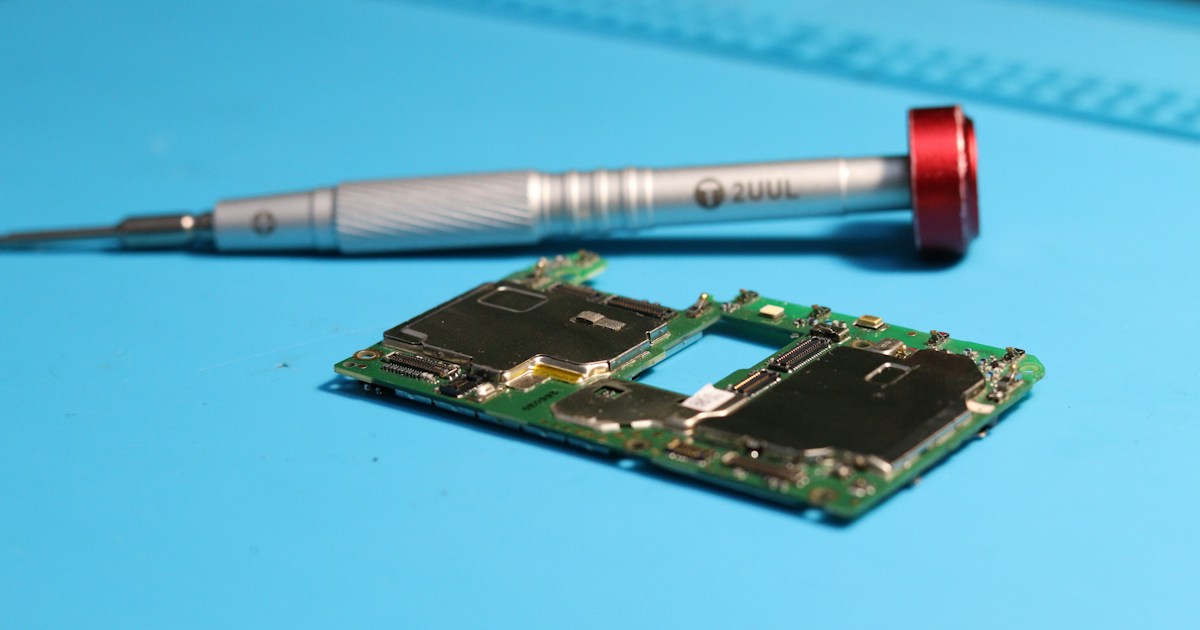 A circuit board is near a screwdriver.