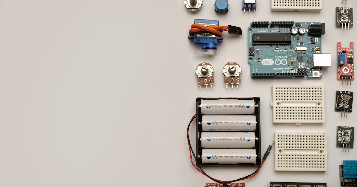 Flat lay out of electronic components with space for text. by Robotic Coding a group of electronic components laid out on a table